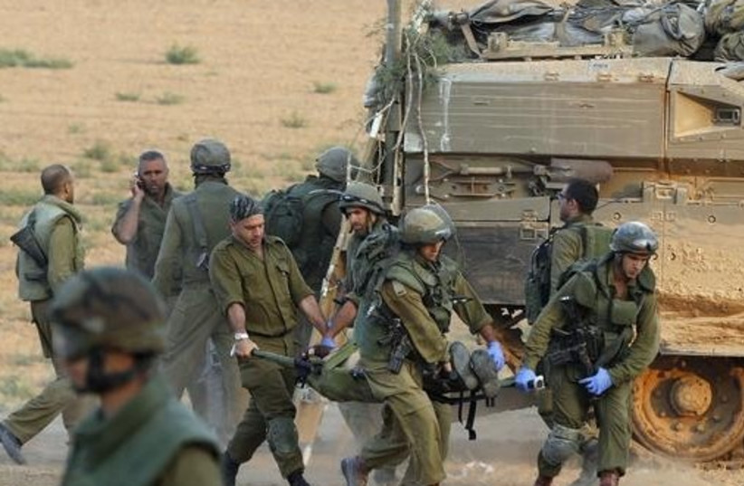 IDF extracts wounded soldiers from Gaza (photo credit: REUTERS)