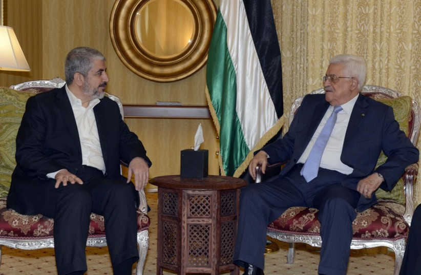 Palestinian President Mahmoud Abbas meets with Hamas leader Khaled Meshaal in Doha (photo credit: REUTERS)