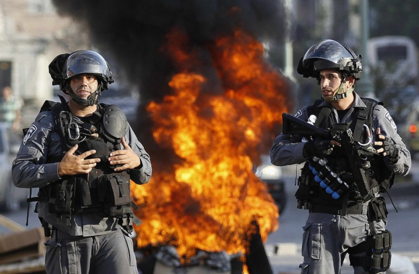 Israeli police officers stand guard during a protest by Israeli Arabs in the northern city of Nazareth. (photo credit: REUTERS)
