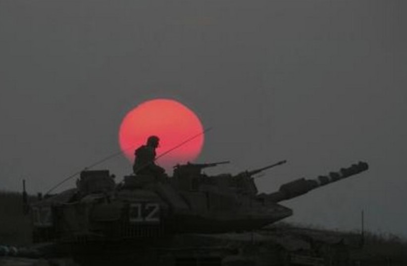 An IDF tank manoeuvres outside the northern Gaza Strip July 21, 2014. (photo credit: REUTERS)