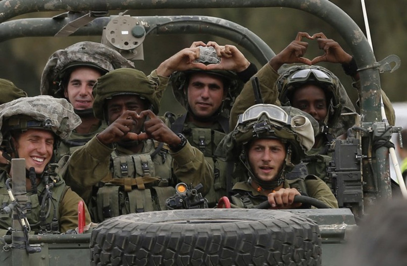IDF soldiers move in towards the southern Gaza Strip, July 19 (photo credit: REUTERS/BAZ RATNER)