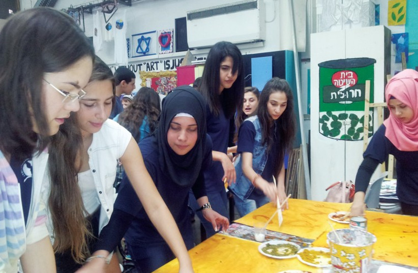 A Book Club meeting of students from the Lady Davis Multidisciplinary High School in Tel Aviv and the Multidisciplinary High School in Taiba. (photo credit: COURTESY AMAL)