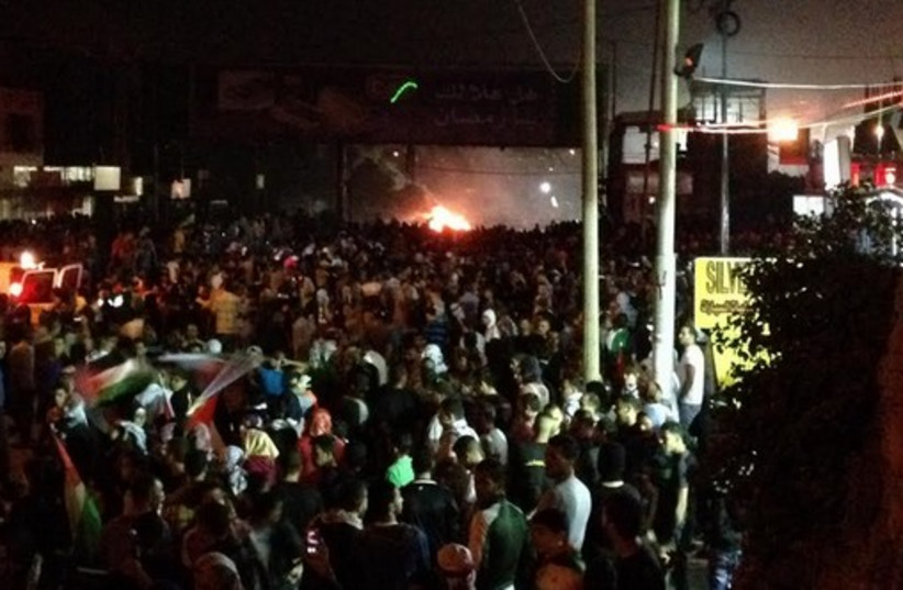 Protests near the Kalandia checkpoint. (photo credit: SETH J. FRANTZMAN)