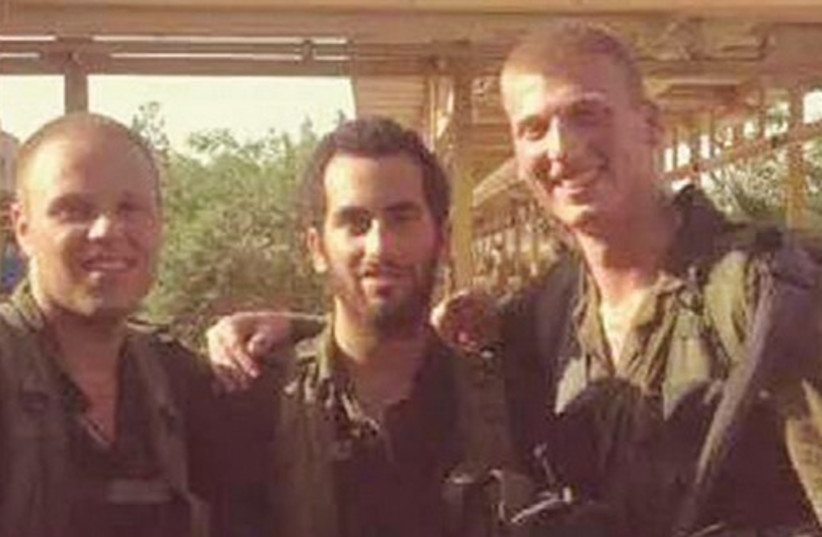 IDF soldier Jordan Low (left), who was injured in Gaza, stands with members of his unit.  (photo credit: BETH TFILOH CONGREGATION/FACEBOOK)