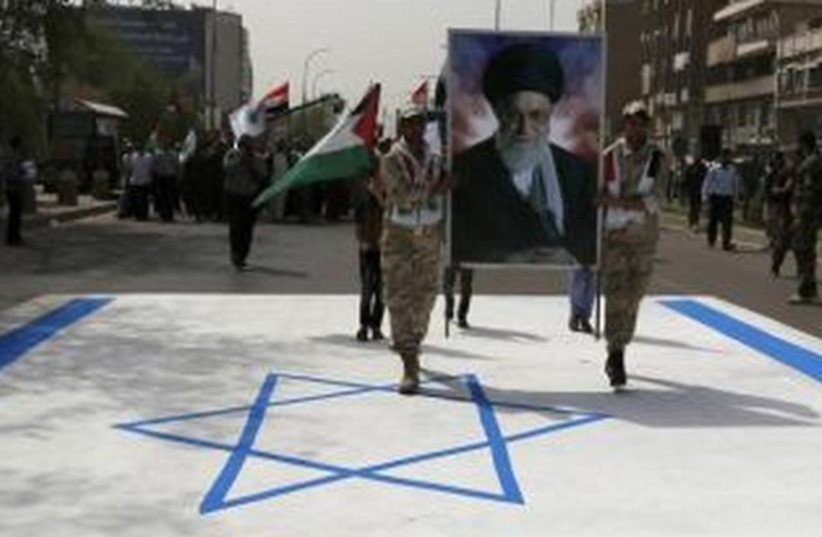 Iraqi Shi'ite men hold a portrait of Iran's Supreme Leader Ayatollah Ali Khamenei during a parade marking the annual al-Quds Day, in Baghdad, July 25, 2014. (photo credit: REUTERS)