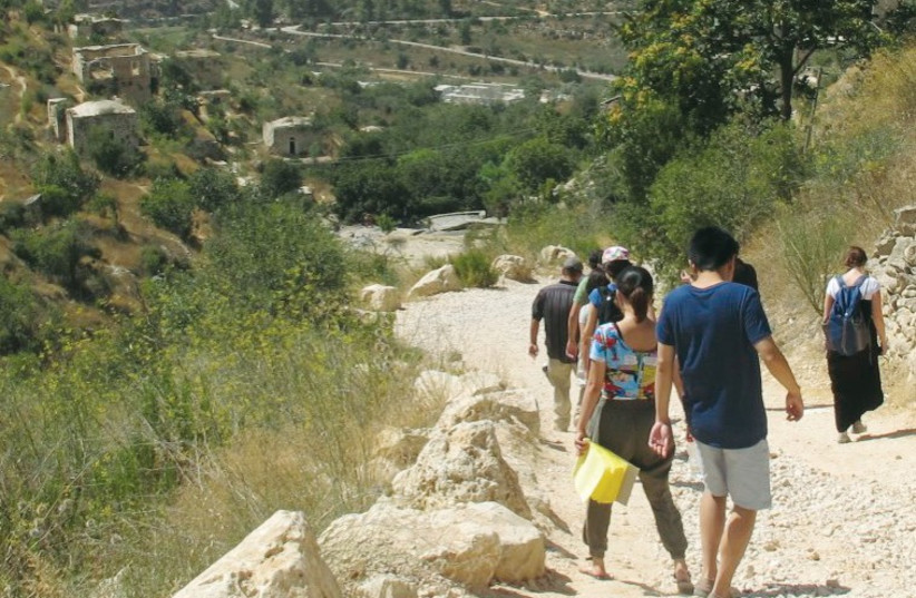 STUDENTS FROM the Hebrew University’s Rothberg International School tour Lifta on the outskirts of Jerusalem. (photo credit: JESSICA GLASNER)