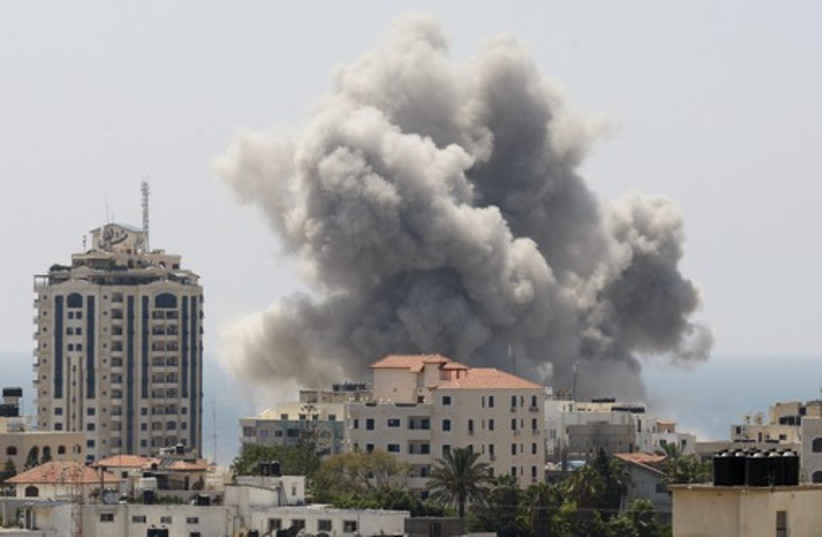 Smoke rises following what witnesses said was an Israeli air strike in Gaza City (photo credit: REUTERS)