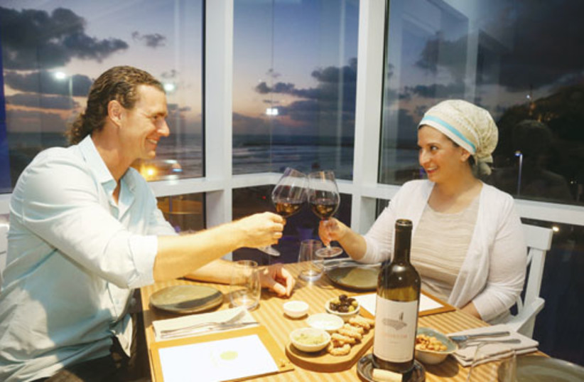 Tom Franz cheers his wife, Dana, over an intimate dinner in Tel Aviv’s Lumina restaurant. (photo credit: MARC ISRAEL SELLEM/THE JERUSALEM POST)