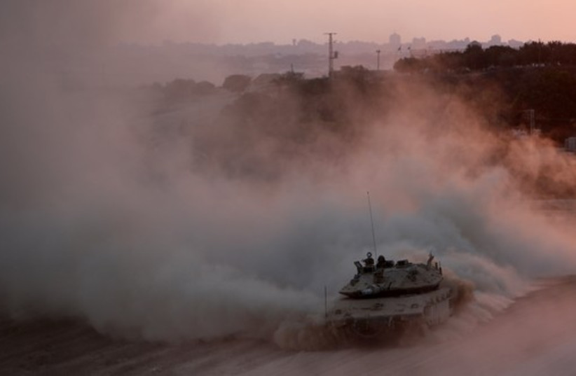 An Israeli tank drives as it returns to Israel from the Gaza Strip (photo credit: REUTERS)