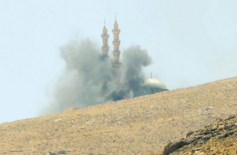 Smoke rises near a mosque as clashes continue between Lebanese army soldiers and Islamists in the Sunni border town of Arsal. (photo credit: REUTERS)