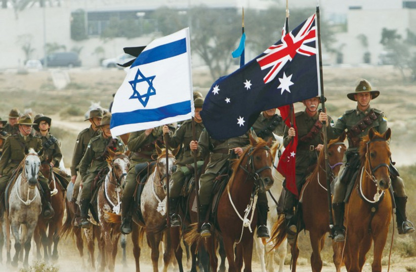 Australians wearing World War I fatigues ride horses during a reenactment marking the anniversary of the Battle of Beersheba. (photo credit: REUTERS)