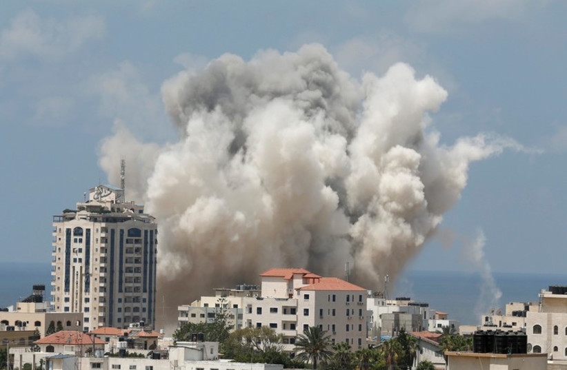 Smoke rises following what witnesses said was an Israeli air strike in Gaza City August 9 (photo credit: REUTERS)