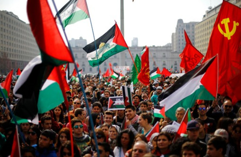 Supporters and members of the Palestine community attend a rally for peace in Gaza, in Santiago, August 9, 2014. (photo credit: REUTERS)