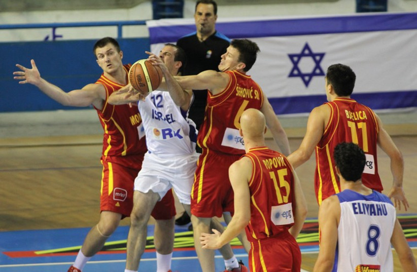 After a bruising defeat to Montenegro, Israel guard Yotam Halperin (center) and his teammates will be aiming to bounce back in their second EuroBasket 2015 qualifier against the Netherlands in Groningen tonight. (photo credit: ISRAEL BASKETBALL ASSOCIATION)