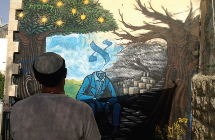 Snare’s most famous piece, ‘The Alef Man,’ in the neighborhood of Nahlaot. (photo credit: ARIEL HENDELMAN)