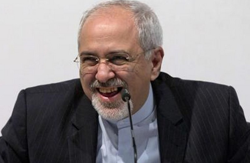 Iranian Foreign Minister Mohammad Javad Zarif smiles during a news conference in Geneva, November 24, 2013. (photo credit: REUTERS)