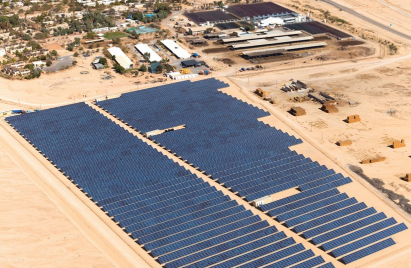 View of Kibbutz Ketura with a field of Arava Power Company photovoltaic panels. (photo credit: COURTESY ITAMAR GRINBERG / ARAVA POWER COMPANY)