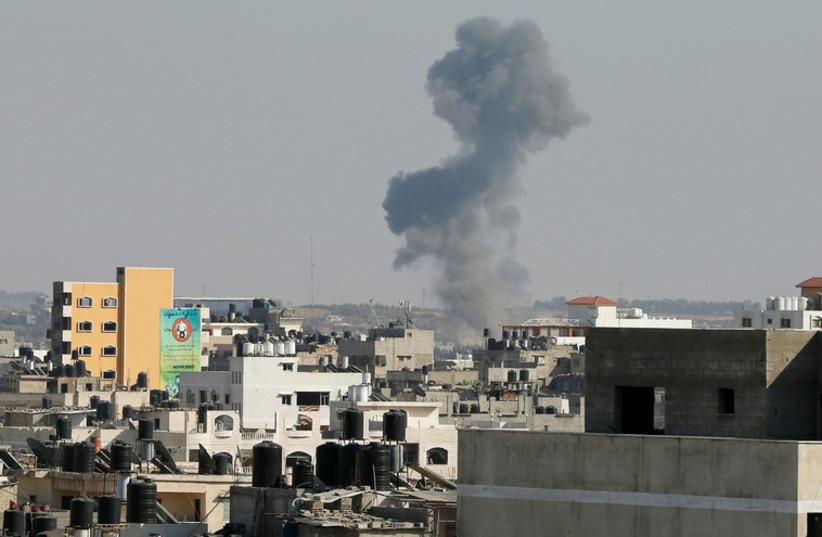 Smoke is seen after what witnesses said was an Israeli air strike in Gaza City. (photo credit: REUTERS)