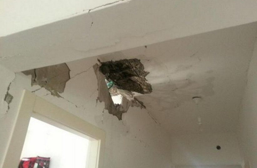 Damage caused by rocket that hit house in Hof Ashkelon council (photo credit: ISRAEL POLICE)