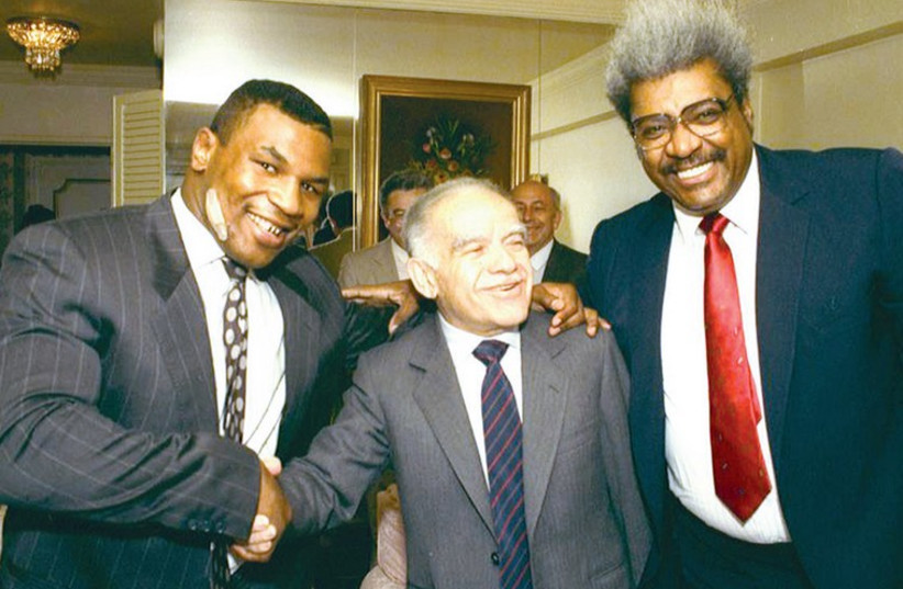 Mike Tyson (left), prime minister Yitzhak Shamir and boxing promoter Don King pose for a rare photo opportunity, organized by then-chief diplomatic adviser Arye Mekel. (photo credit: FACEBOOK)