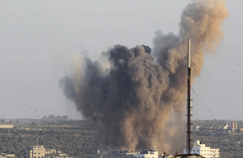 Smoke rises following what witnesses said was an Israeli air strike in Gaza (photo credit: REUTERS)