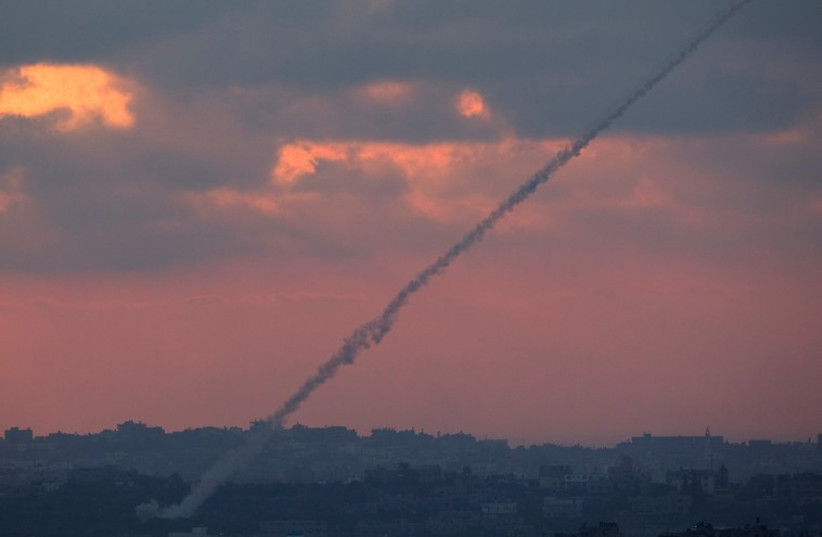 Smoke trails are seen as rockets are launched from the Gaza Strip towards Israel. (photo credit: REUTERS)