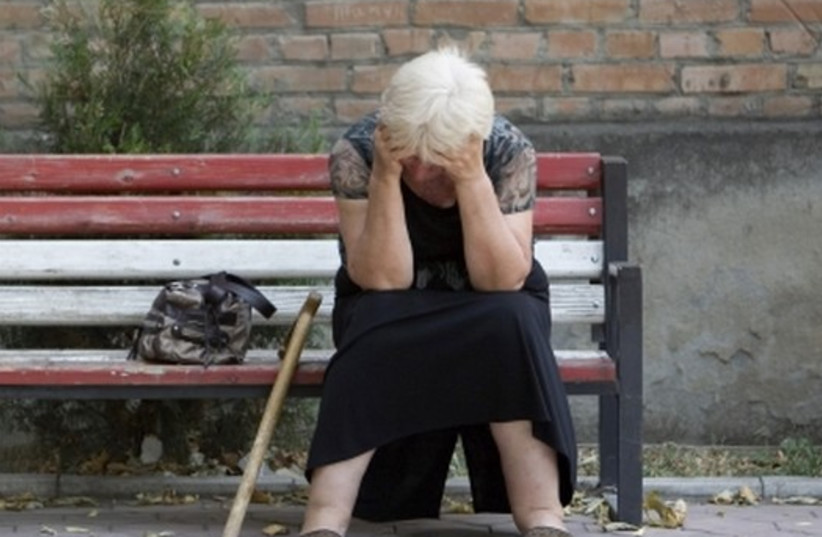 An elderly woman suffers from PTSD. [illustrative] (photo credit: REUTERS)