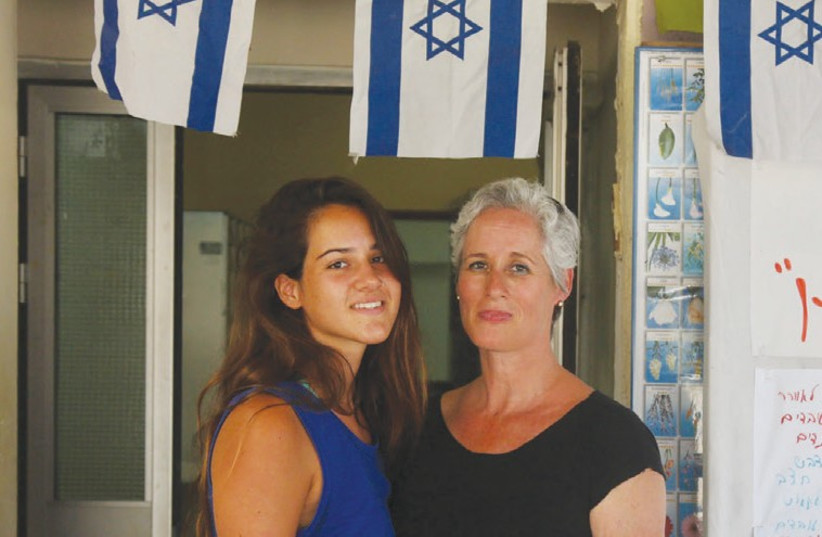 OFRI VOLK (right) and her 17-year-old daughter, Gal, stand by the entrance to the shelter on Netiv Ha’asara, a moshav less than 1 km. from the Gaza border on Wednesday. (photo credit: MARC ISRAEL SELLEM)