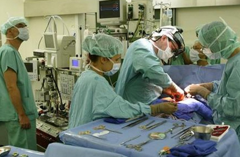 Doctors perform surgery [illustrative]. (photo credit: REUTERS)