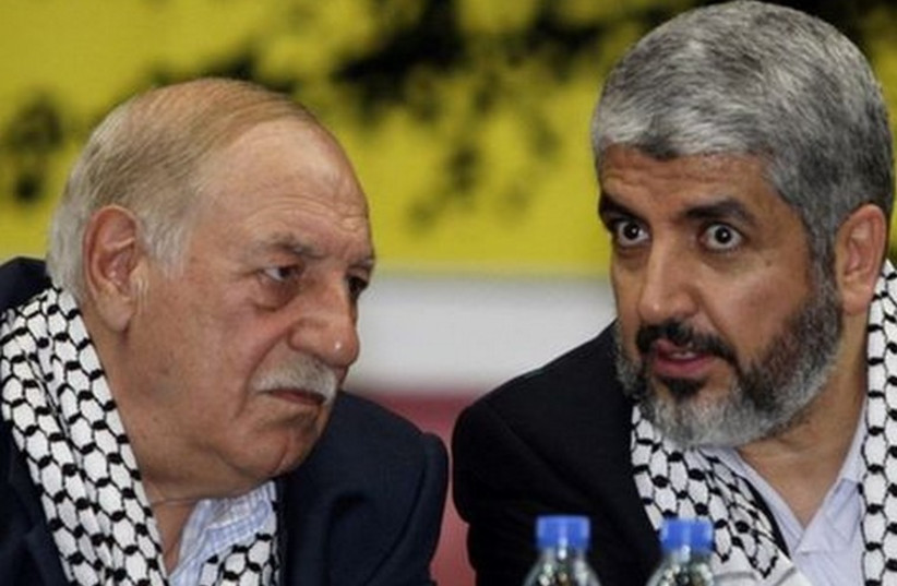 Hamas leader Khaled Mashaal (R) chats with Ahmed Jibril, head of the Popular Front for the Liberation of Palestine-General Command (PFLP-GC). (photo credit: REUTERS)