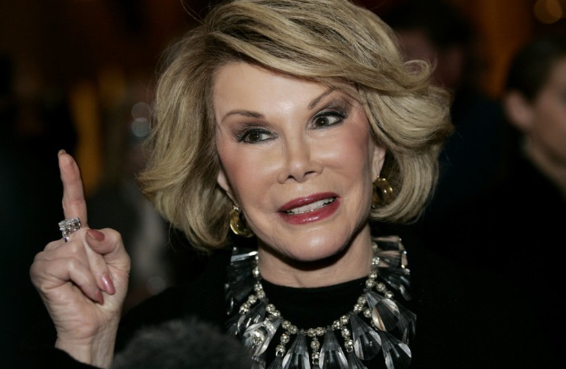 Comedian Joan Rivers talks to reporters as she arrives for a gala honoring the late stand-up comedian George Carlin. (photo credit: REUTERS)