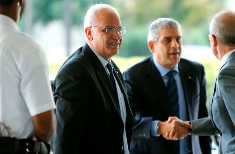 Palestinian Chief Negotiator Saeb Erekat (C) and Maen Rashid Areikat (2nd R), chief of the PLO)delegation in Washington, arrive to meet with US Secretary of State John Kerry in Washington September 3, 2014. (photo credit: REUTERS)