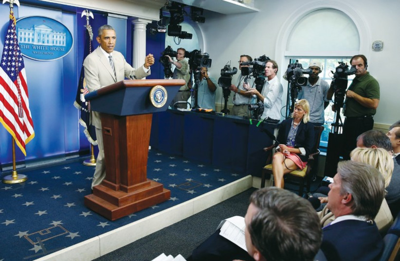 US president Barack Obama addresses reporters in the White House press briefing room, (photo credit: REUTERS)