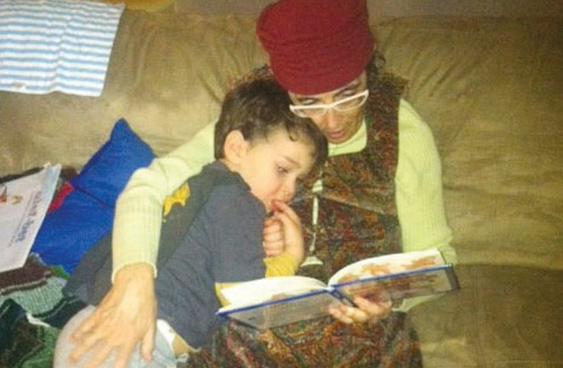 A happy Fineblum reads to her grandson. (photo credit: Courtesy)