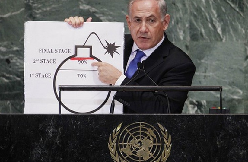 Prime Minister Binyamin Netanyahu points to a diagram of a bomb at the UN. (photo credit: REUTERS)