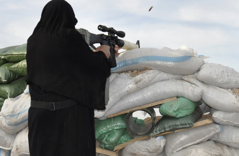 Veiled woman shoots gun (illustrative)‏ (photo credit: REUTERS)