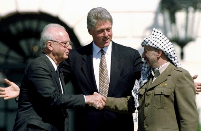 Slain Israeli Prime Minister Rabin with former US President Bill Clinton and former PLO President Yasser Arafat after signing the Oslo Accords at the White House on September 13, 1993.  (photo credit: REUTERS)