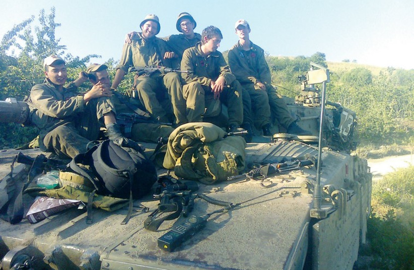Avraham Itzhak Mendelevich (inset) and on a tank with his fellow soldiers. (photo credit: Courtesy)