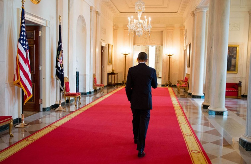 President Barack Obama walks through the Cross Hall of the White House, Aug. 8, 2013 (photo credit: OFFICIAL WHITE HOUSE PHOTO BY PETE SOUZA)