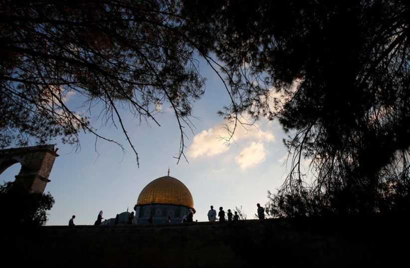  Palestinians in front of the Dome of the Rock on Temple Mount, in Jerusalem's Old City (photo credit: REUTERS)