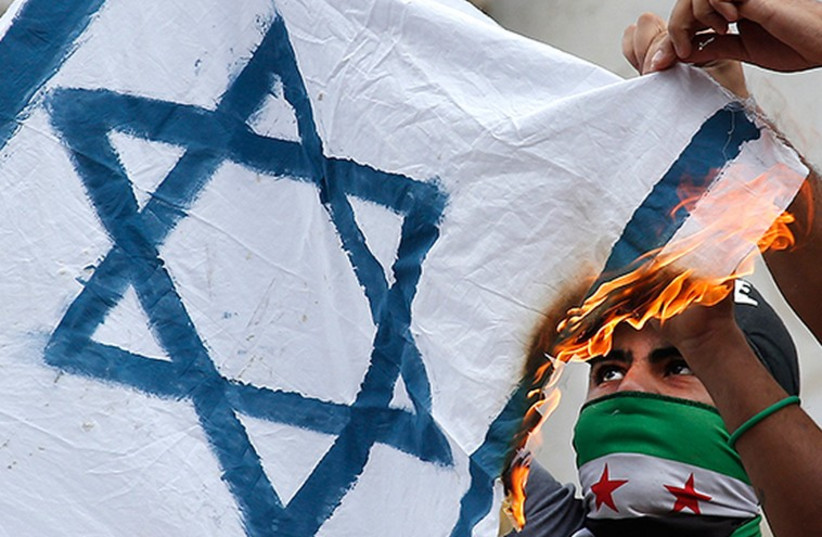 Parisians burn an Israeli flag (photo credit: REUTERS)