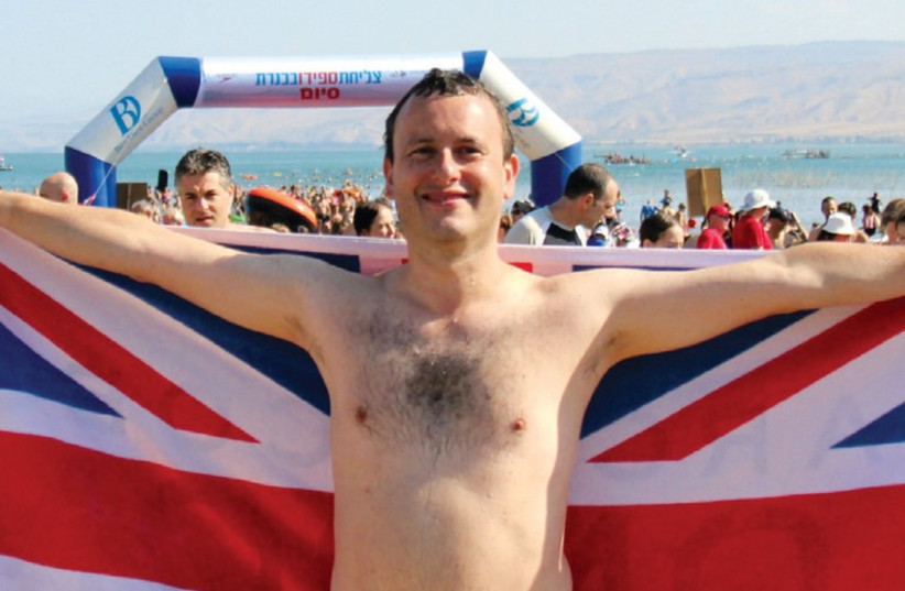BRITISH AMBASSADOR Matthew Gould swims proudly for the flag in the Sea of Galilee. (photo credit: BRITISH EMBASSY IN ISRAEL)