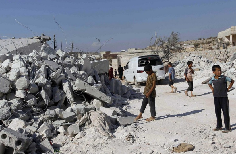 Rubble from US air strike in Syria's Idlib province (photo credit: REUTERS)