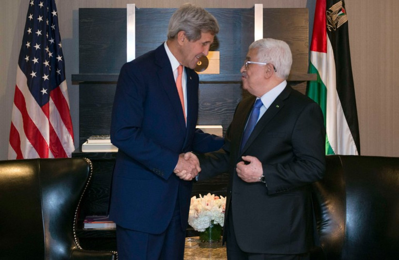 US Secretary of State John Kerry shakes hands with Palestinian Authority President Mahmoud Abbas in New York, September 23 (photo credit: REUTERS)