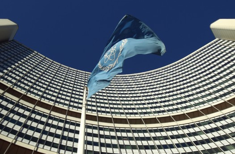  The flag of the International Atomic Energy Agency (IAEA) flies in front of its headquarters in Vienna  (photo credit: REUTERS)