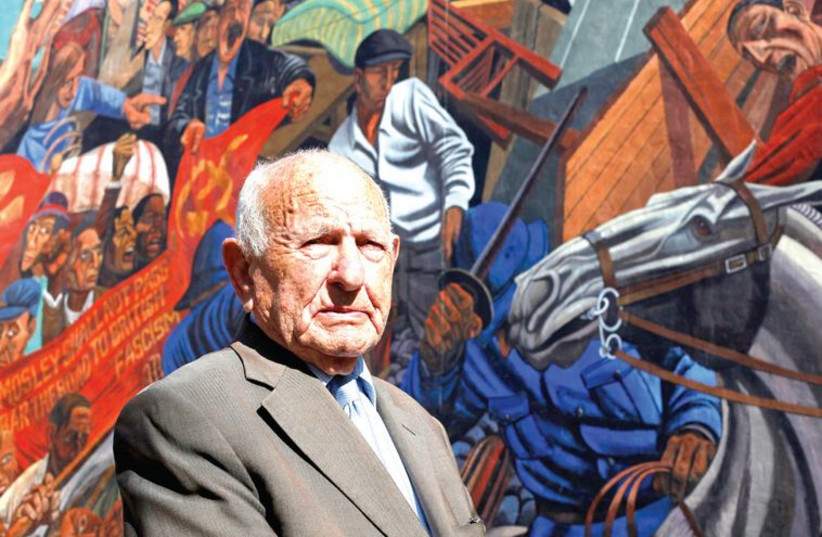 Max Levitas, 96, who participated in the 1936 ‘Battle of Cable Street’, poses 75 years later in front of a mural depicting the clash. (photo credit: REUTERS)