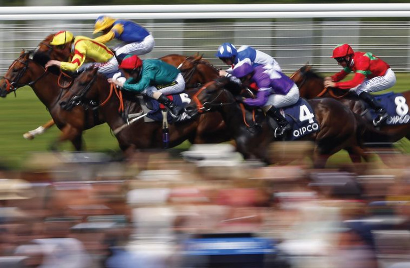 Horse racing for the finish line at Goodwood racecourse in southern England, July 31. (photo credit: EDDIE KEOGH / REUTERS)