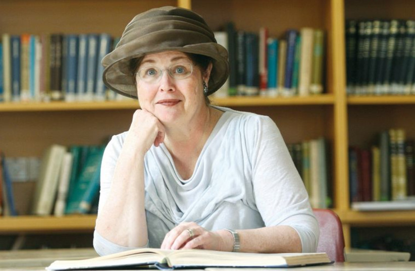 Malka Bina sits in the library of the institute she founded, the Sadie Rennert Women’s Institute for Torah Studies. (photo credit: Courtesy)