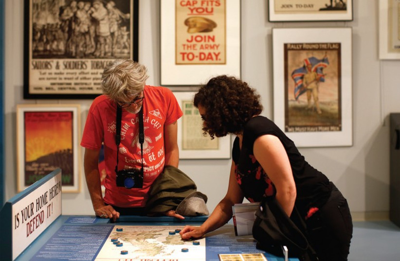 VISITORS LOOK at a map displayed in the exhibition at the Museum of the Great War in Meaux, near Paris (photo credit: REUTERS)