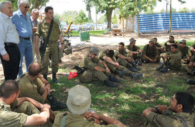 Agriculture Minister Yair Shamir speaks to soldiers in the Eshkol region during this summer’s conflict with Gaza. (photo credit: JEVGENIYA KRAVCHIK)
